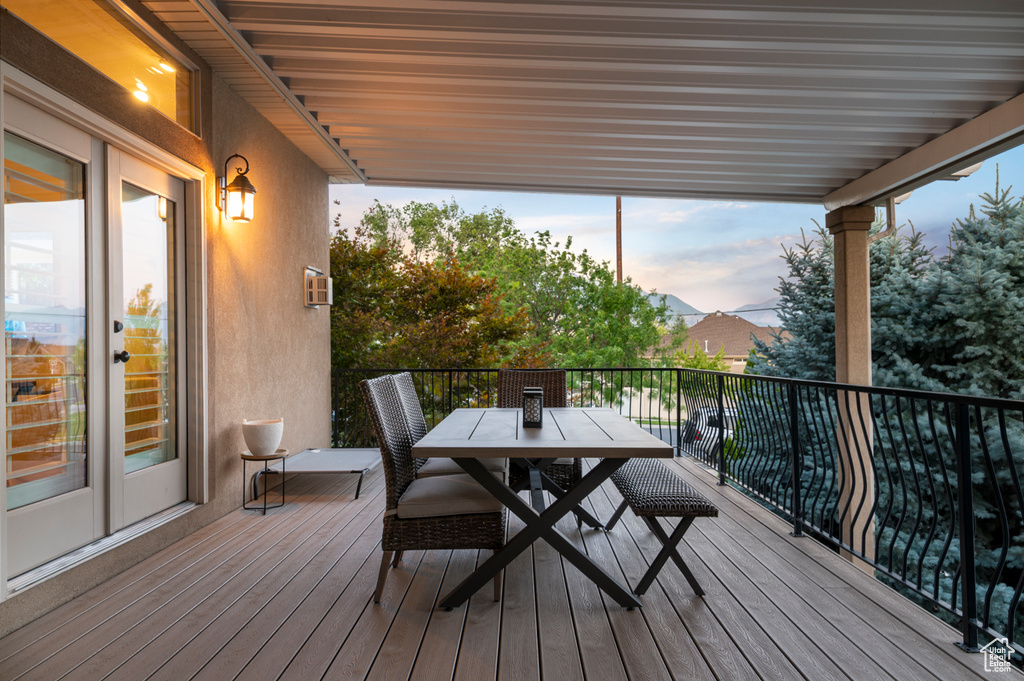 Deck at dusk featuring outdoor dining area