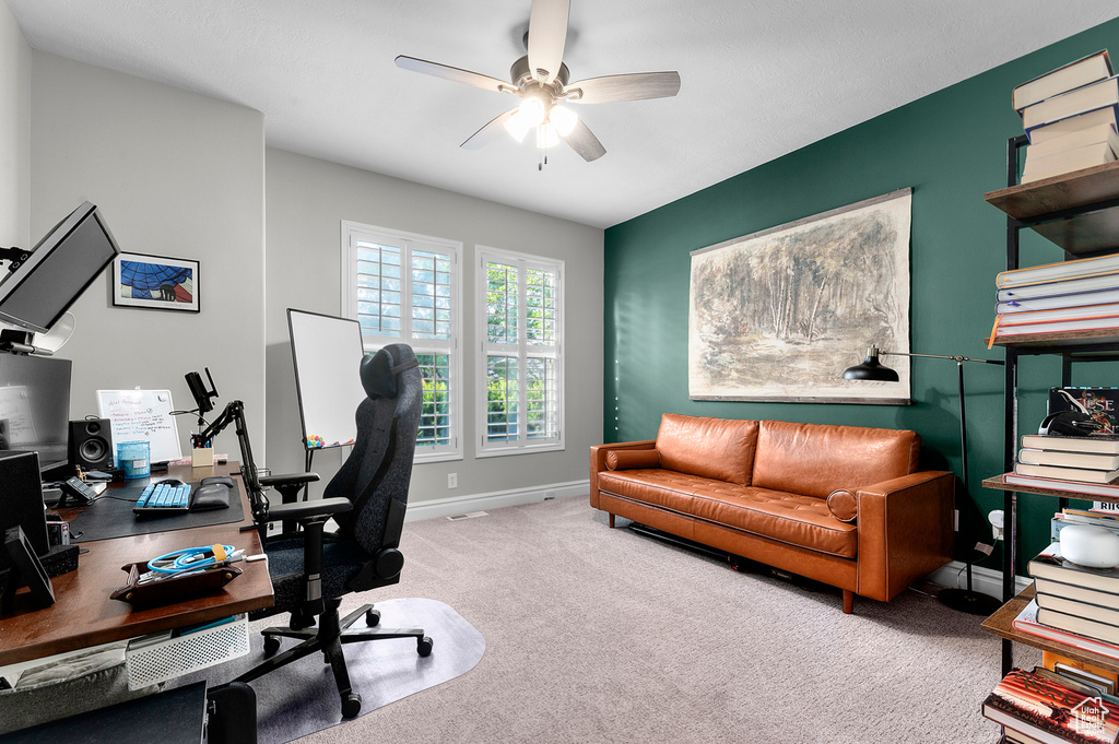 Office area featuring carpet and a ceiling fan