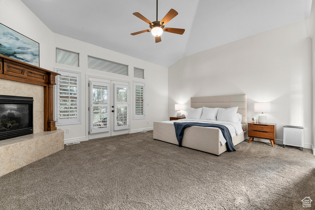 Bedroom with high vaulted ceiling, access to exterior, carpet floors, a high end fireplace, and a ceiling fan