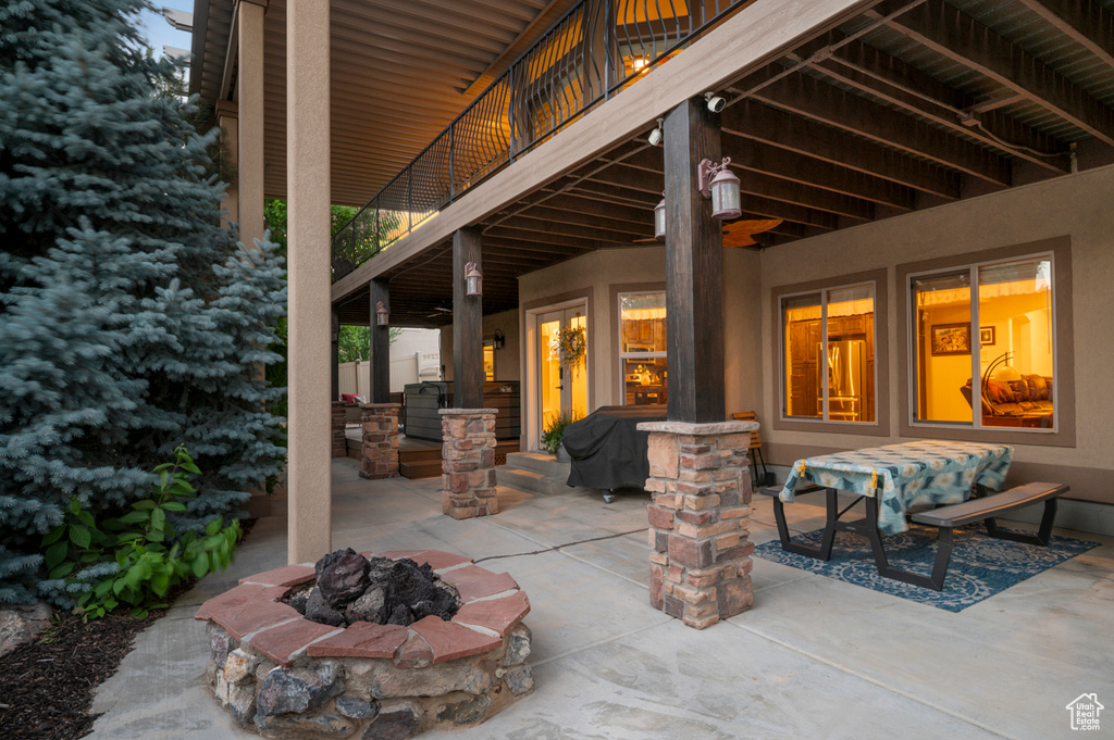 View of patio with an outdoor fire pit and grilling area