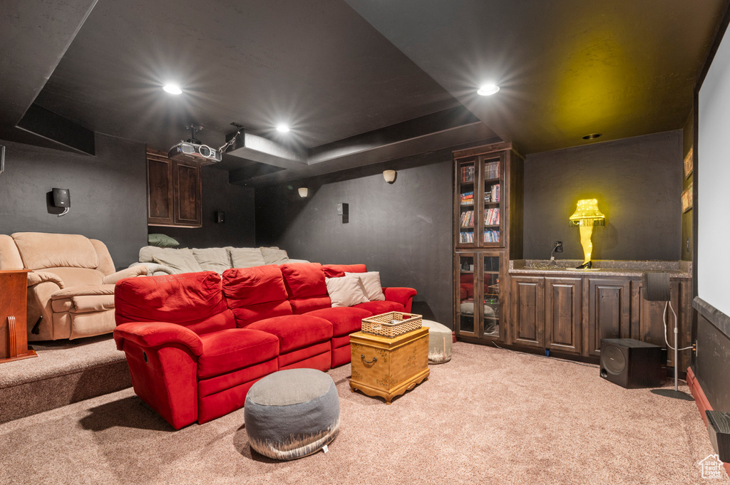 Carpeted home theater room with recessed lighting