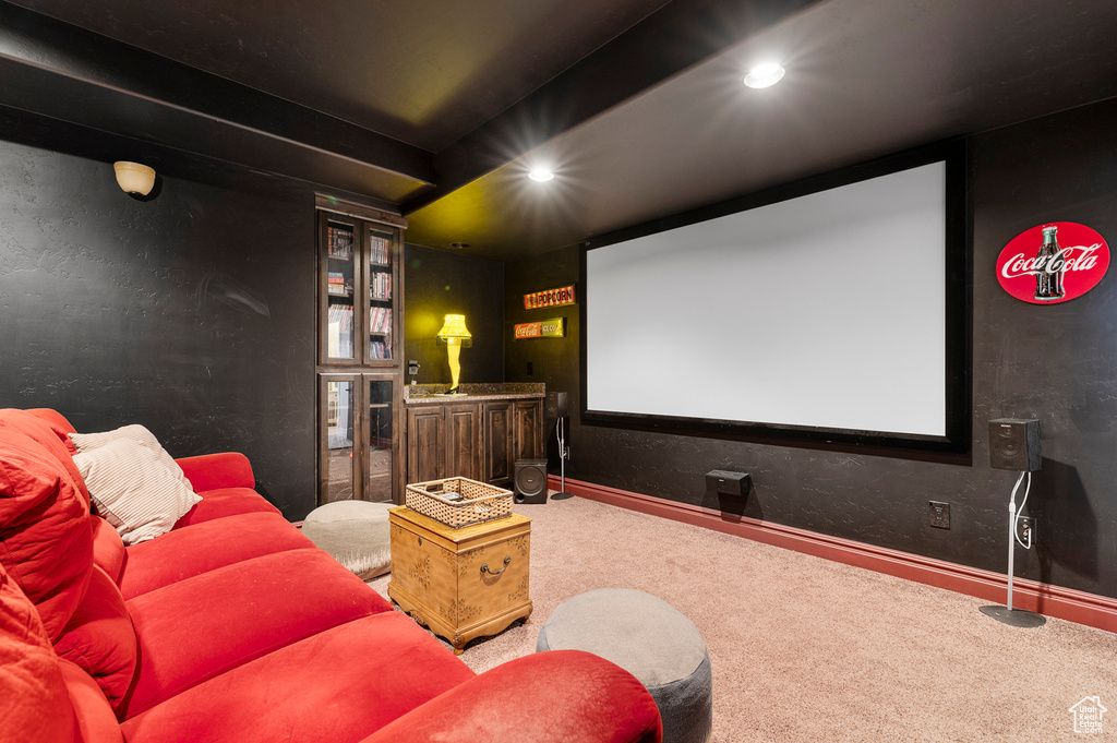 Carpeted home theater room featuring recessed lighting and baseboards