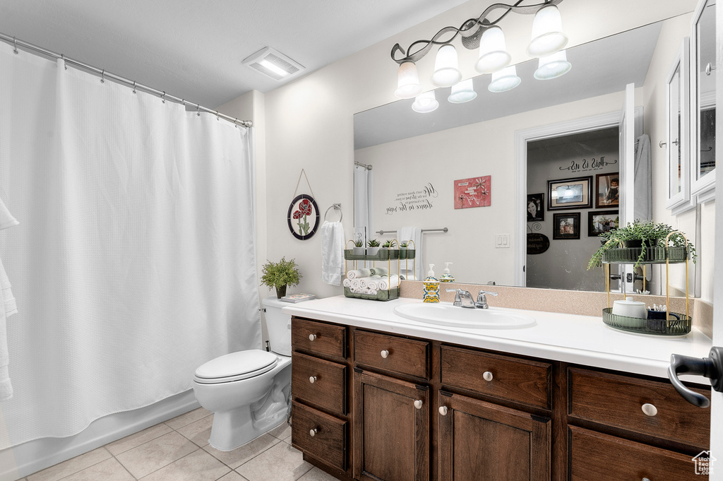 Full bathroom featuring tile patterned floors, vanity, and shower / bath combo