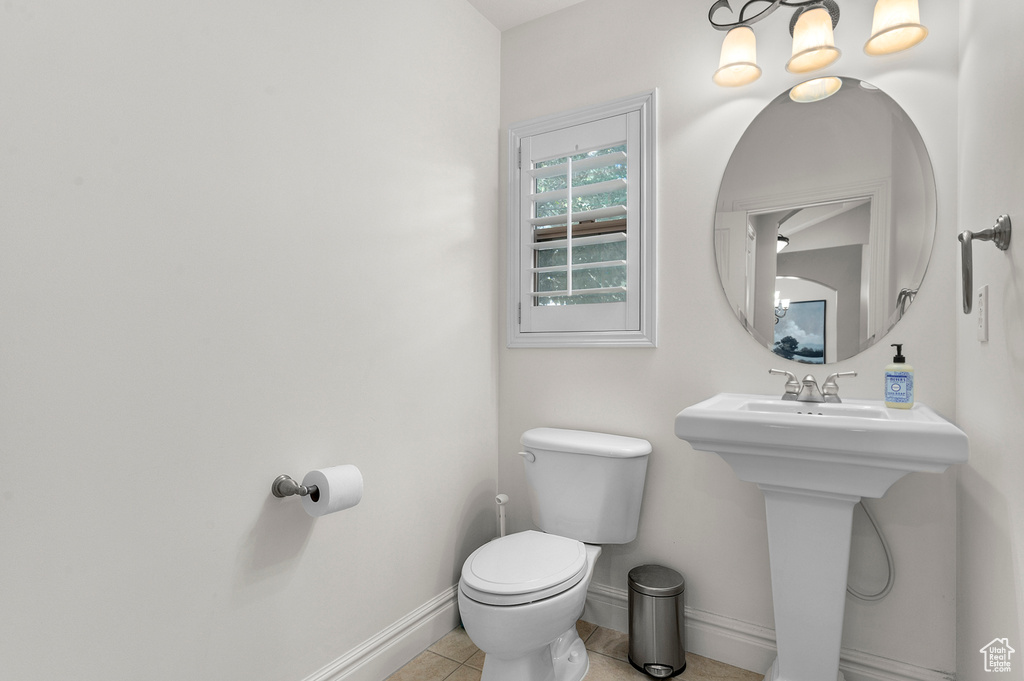 Half bath featuring toilet and tile patterned flooring