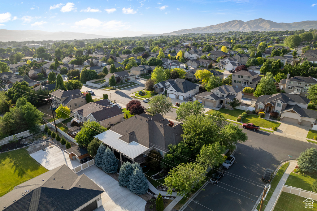 Aerial view of residential area featuring a mountainous background