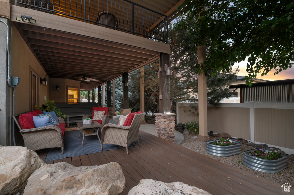 Deck with outdoor lounge area, a ceiling fan, and a jacuzzi