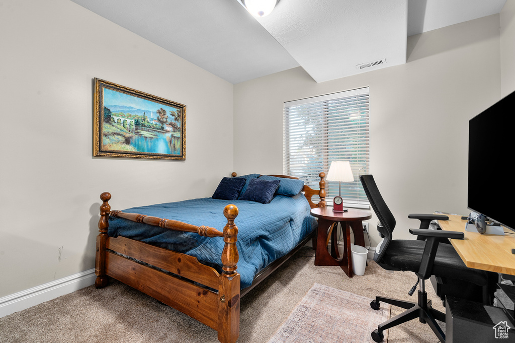 Bedroom featuring carpet flooring and a desk