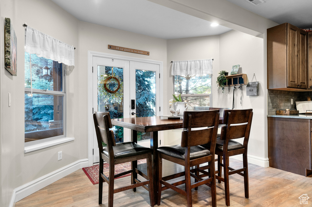 Dining area featuring light wood-type flooring, french doors, and recessed lighting