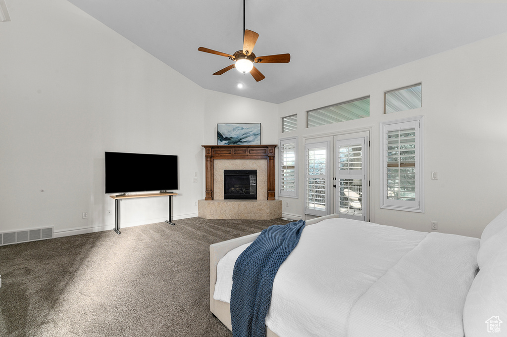 Carpeted bedroom with access to outside, vaulted ceiling, a high end fireplace, a ceiling fan, and french doors