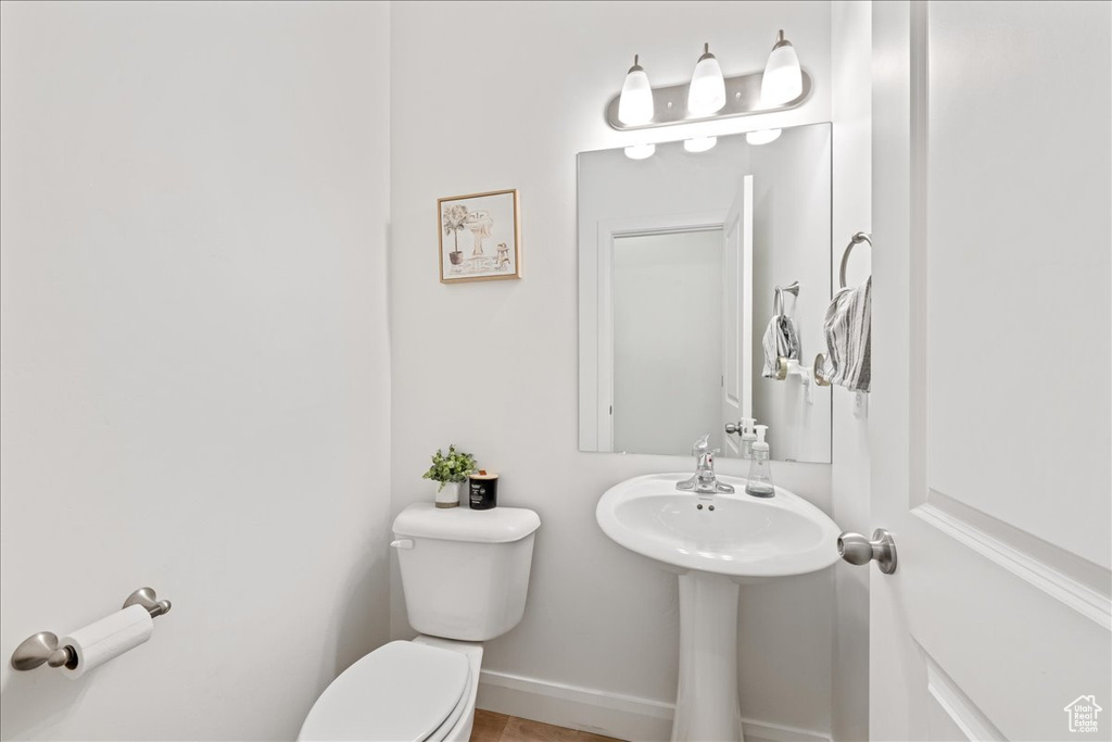 Bathroom featuring toilet and baseboards