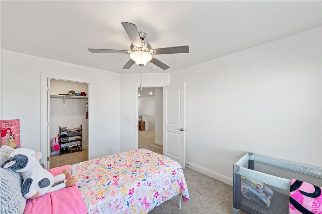 Bedroom with carpet floors, a ceiling fan, and a closet