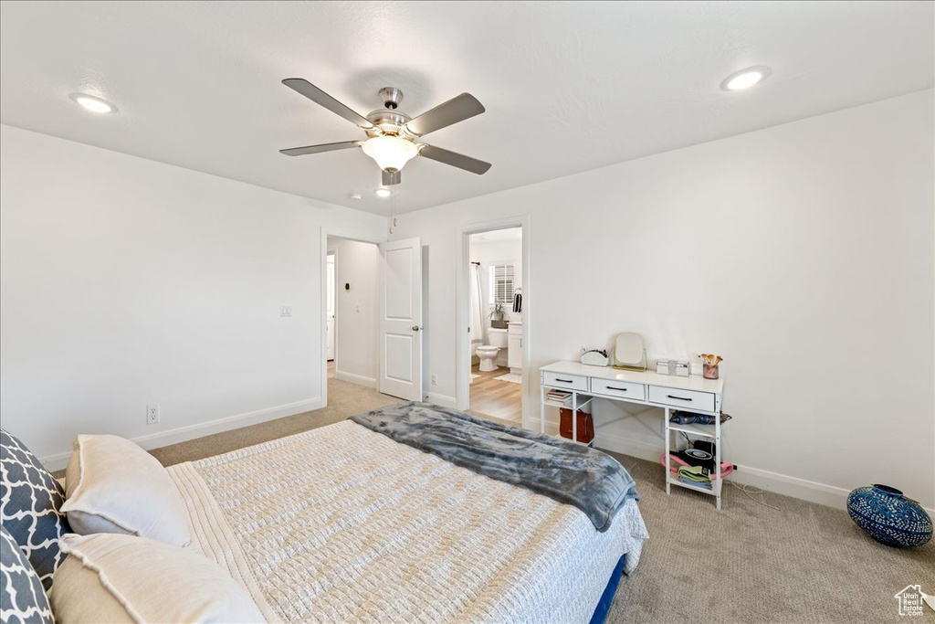 Bedroom featuring light carpet, recessed lighting, a ceiling fan, and ensuite bathroom
