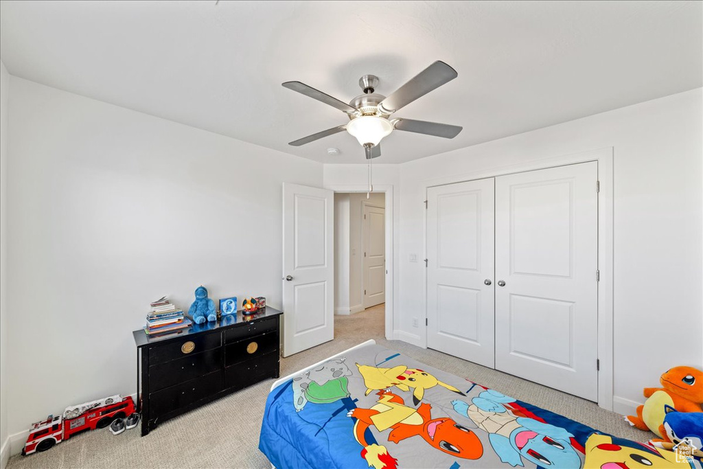 Bedroom featuring carpet floors, a closet, and a ceiling fan