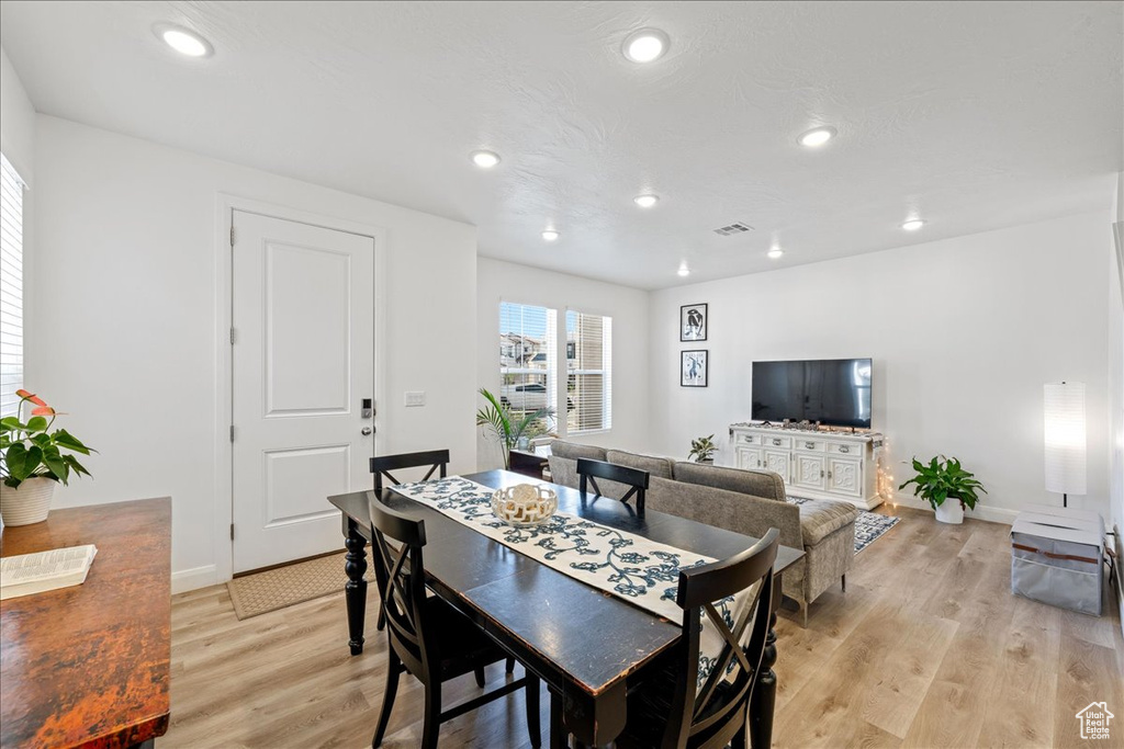 Dining room featuring light wood-style floors and recessed lighting