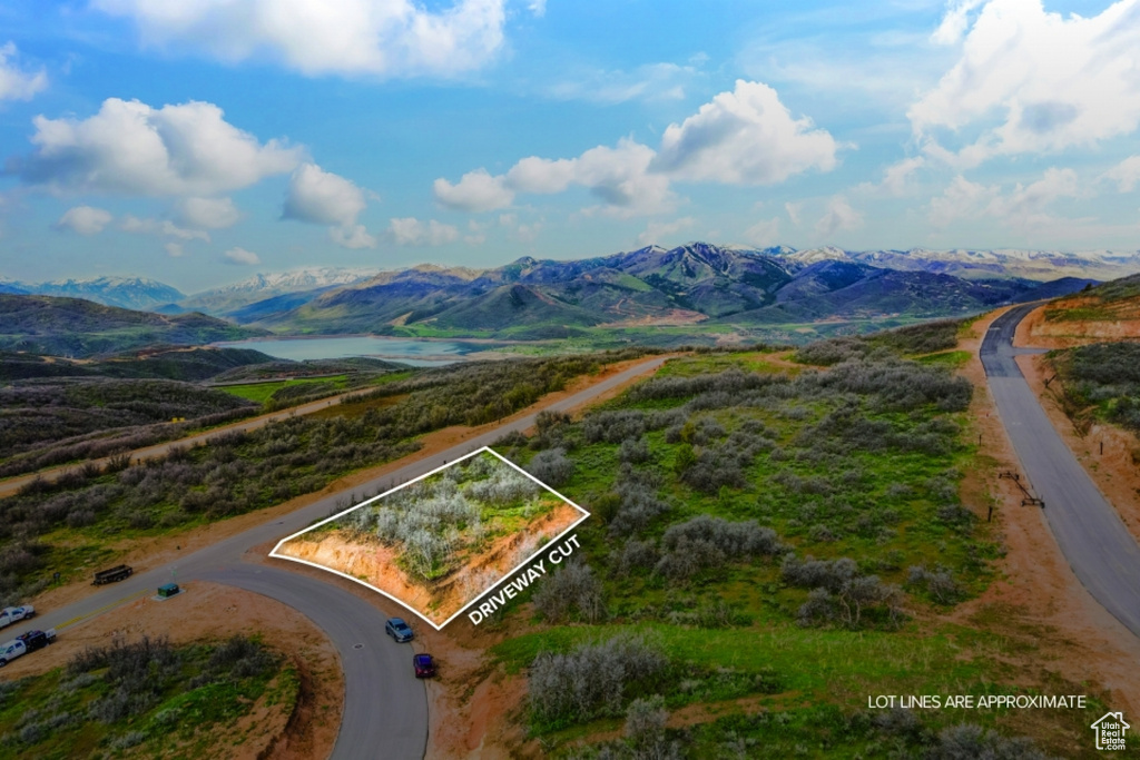 Aerial overview of property\'s location featuring a mountainous background and property boundaries highlighted