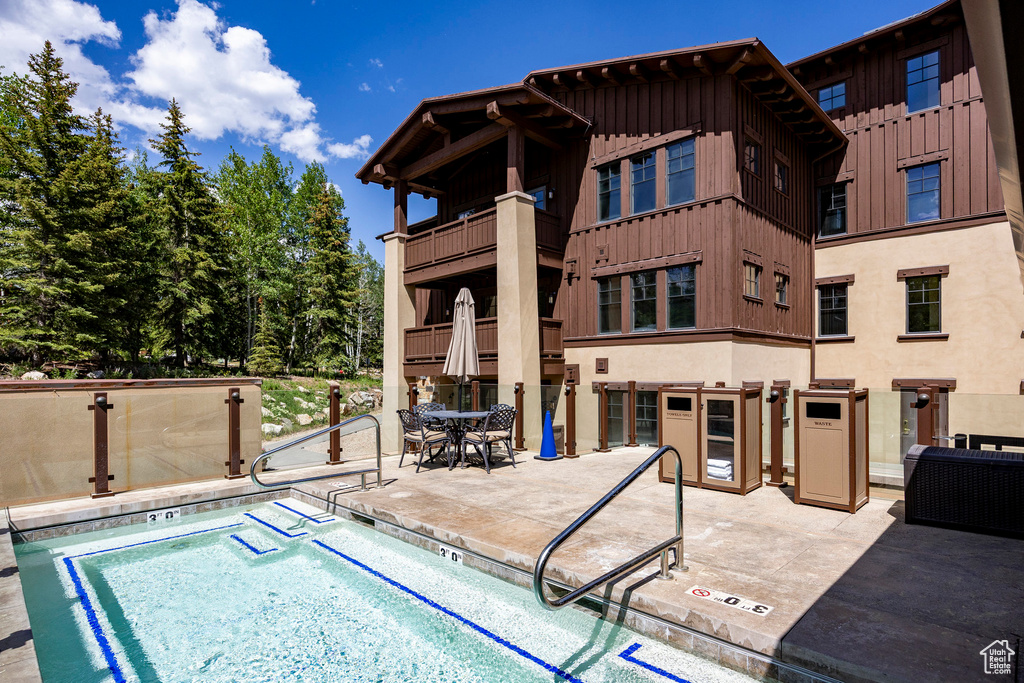 View of swimming pool with a patio and a swimming pool
