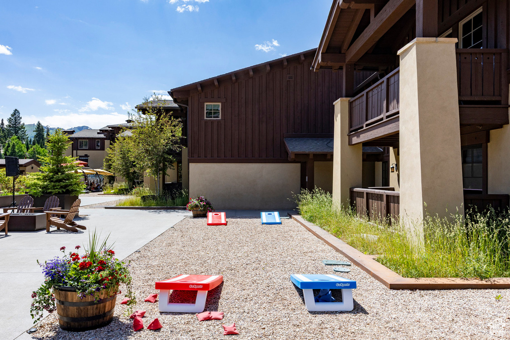 View of property's community featuring an outdoor fire pit and a patio area