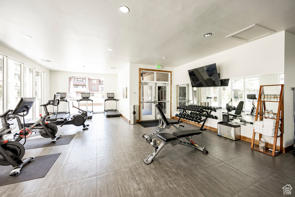 Workout area featuring plenty of natural light, recessed lighting, and attic access
