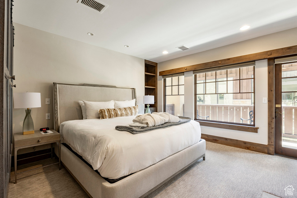 Carpeted bedroom with recessed lighting