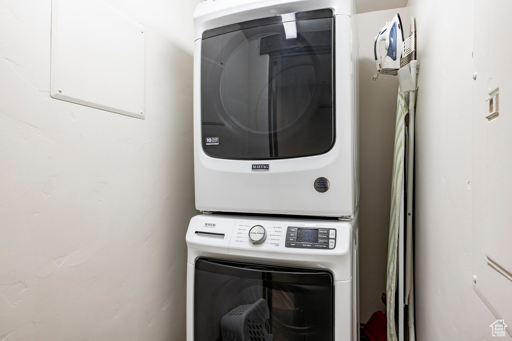 Washroom with stacked washer and clothes dryer