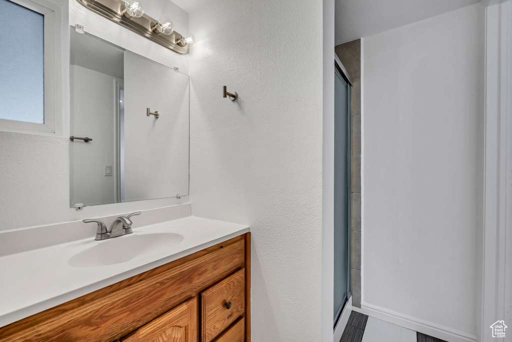 Full bathroom featuring vanity and a shower stall