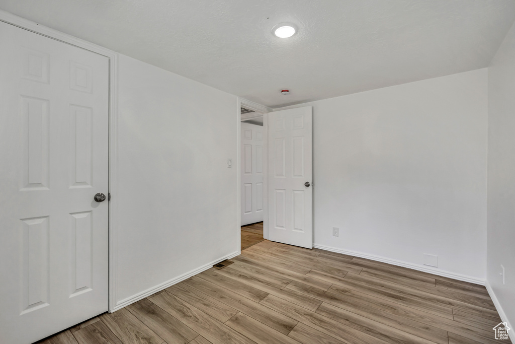 Unfurnished bedroom featuring baseboards and light wood-style flooring