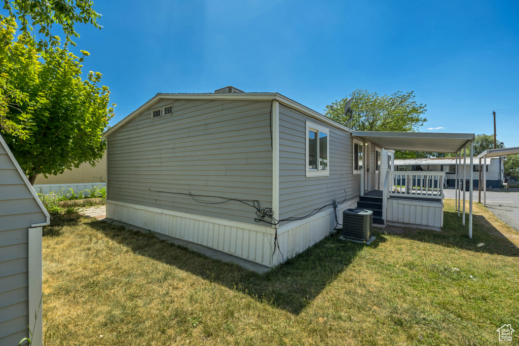 View of property exterior with a yard