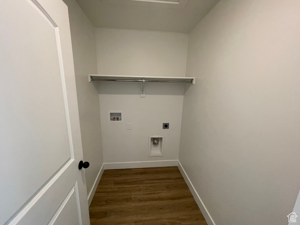 Laundry room featuring dark wood-type flooring, washer hookup, and electric dryer hookup