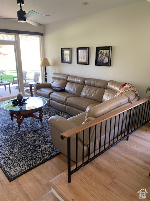 Living area featuring wood finished floors and ceiling fan