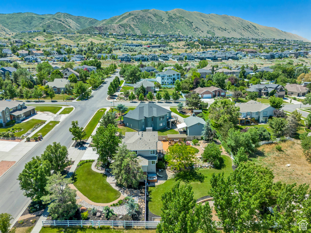 View of property location featuring mountains and nearby suburban area