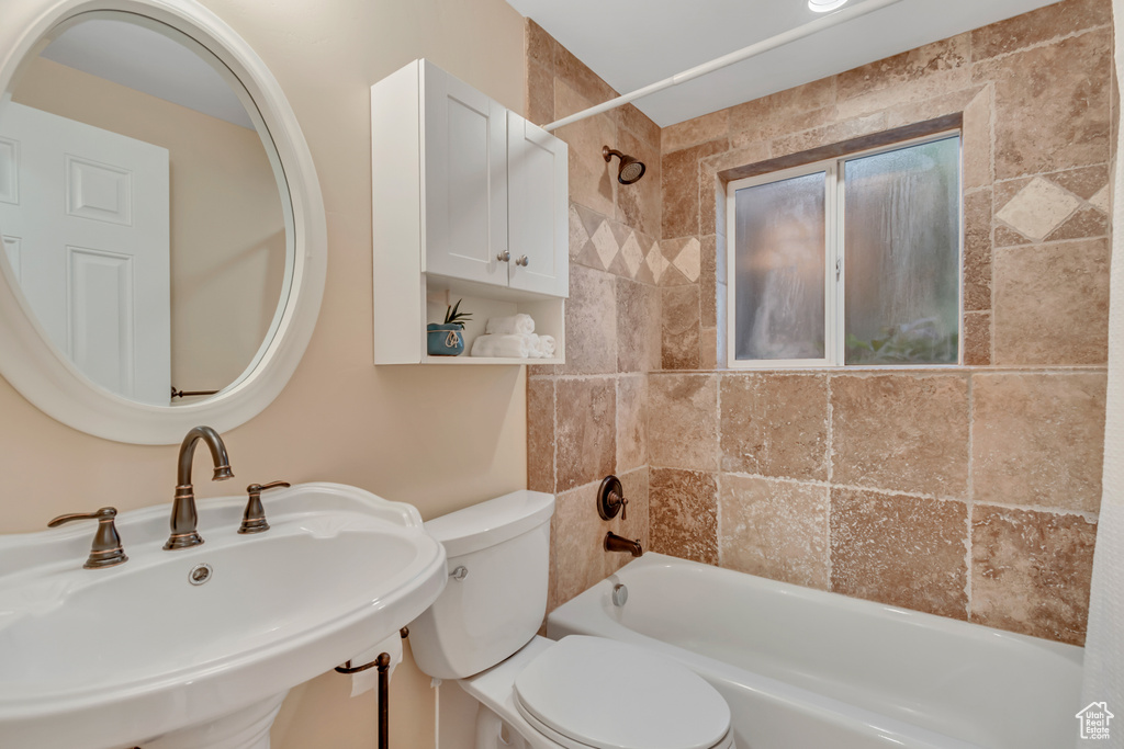 Bathroom with a sink and shower / bathtub combination