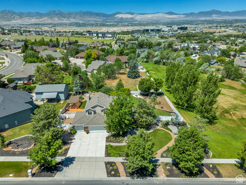 Aerial overview of property\'s location featuring mountains and nearby suburban area