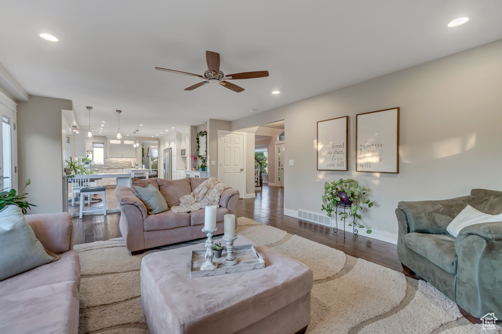 Living room with ceiling fan, wood finished floors, and recessed lighting