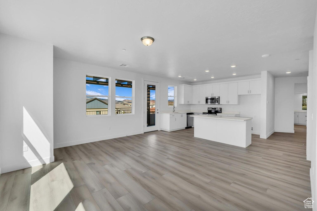 Unfurnished living room with recessed lighting and light wood-style flooring