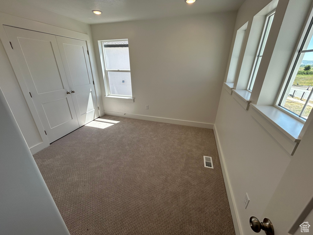 Unfurnished bedroom featuring carpet floors and recessed lighting