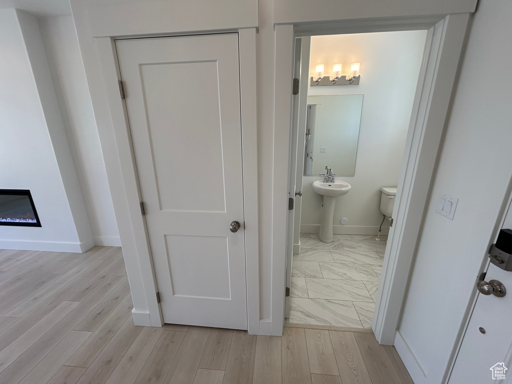 Bathroom with baseboards and wood finished floors