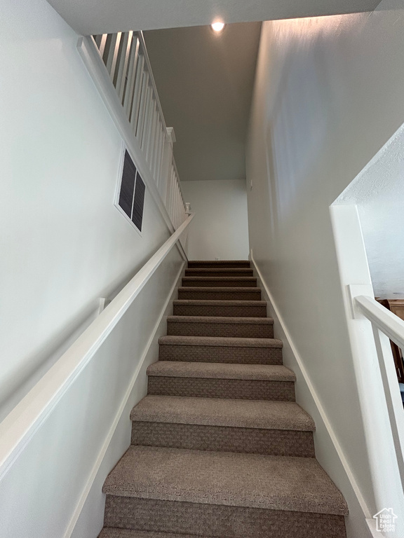 Staircase featuring recessed lighting