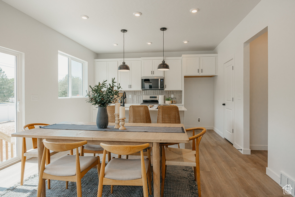 Dining room featuring light wood-type flooring and recessed lighting