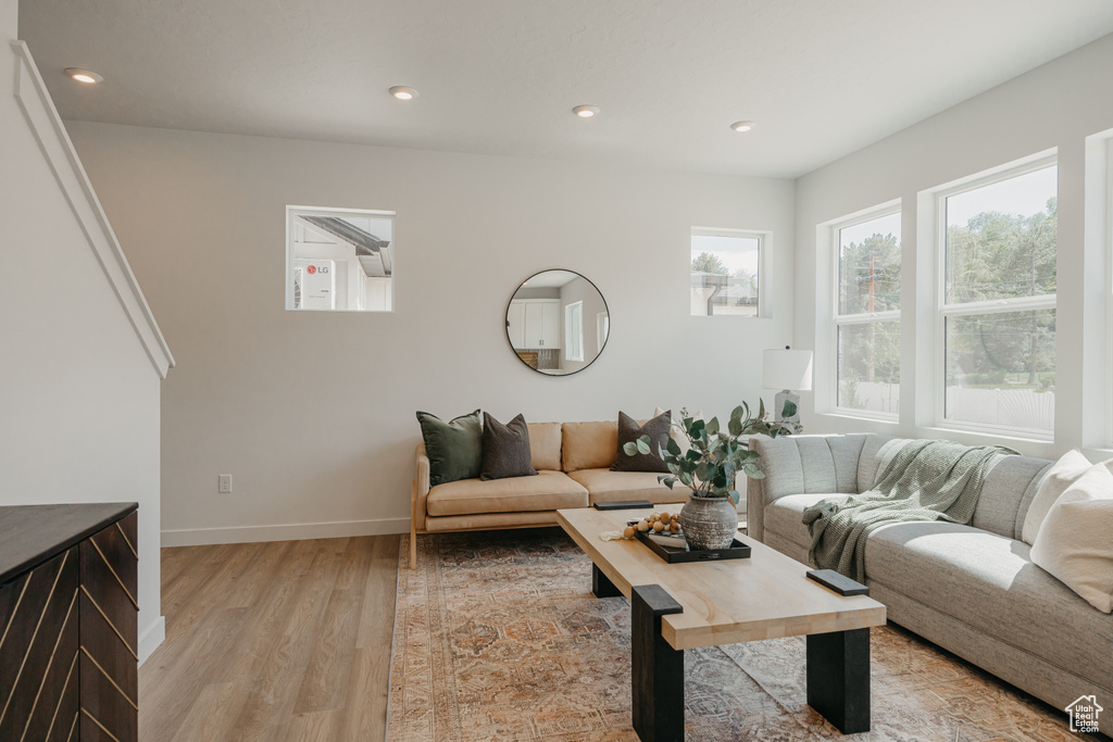 Living area featuring light wood-style flooring and recessed lighting