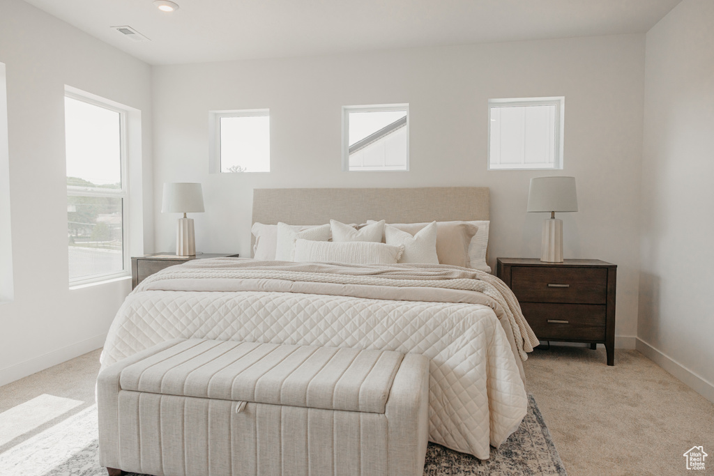 Bedroom with light carpet and baseboards
