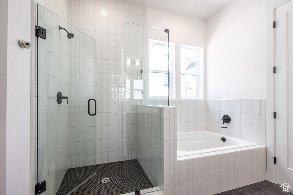 Full bath with a bath, a stall shower, and tile patterned flooring