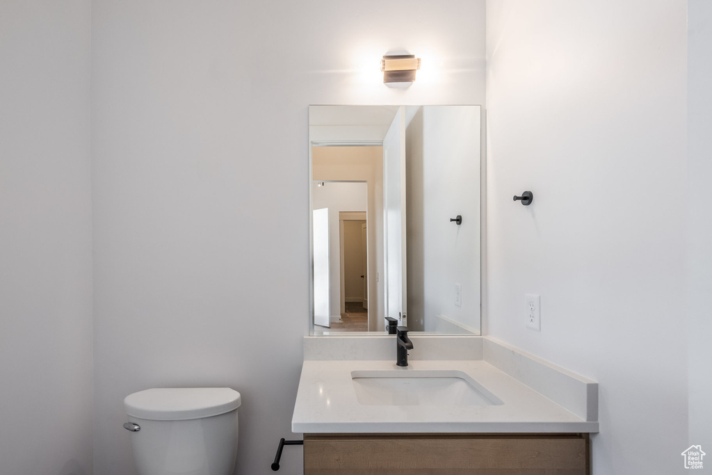 Half bathroom with toilet and vanity