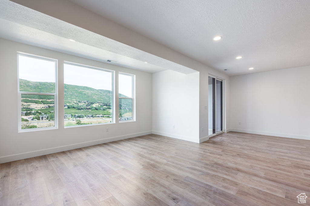 Unfurnished room with recessed lighting and light wood-style flooring