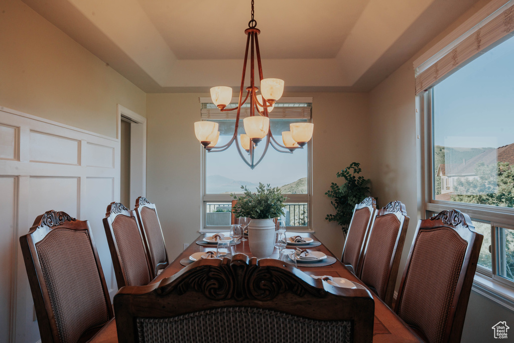 Dining room featuring a chandelier and a tray ceiling