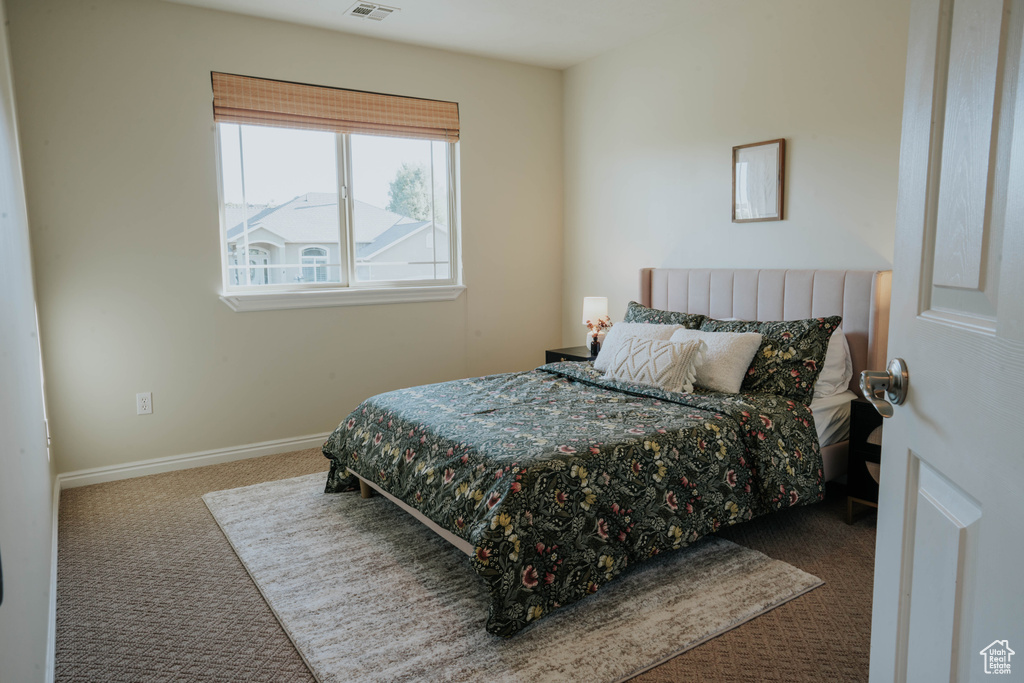 Bedroom featuring carpet floors and baseboards