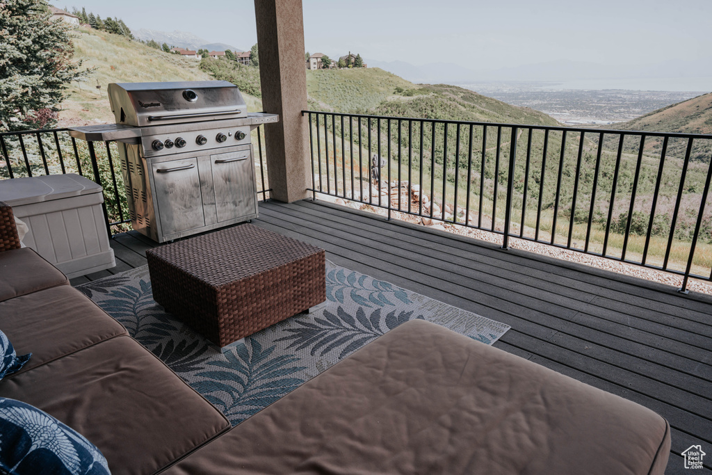 Wooden deck with grilling area and a mountain view