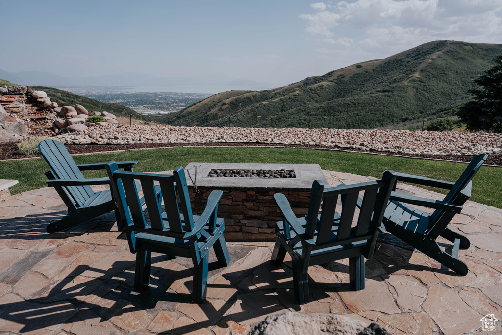 View of patio / terrace with a fire pit and a mountain view