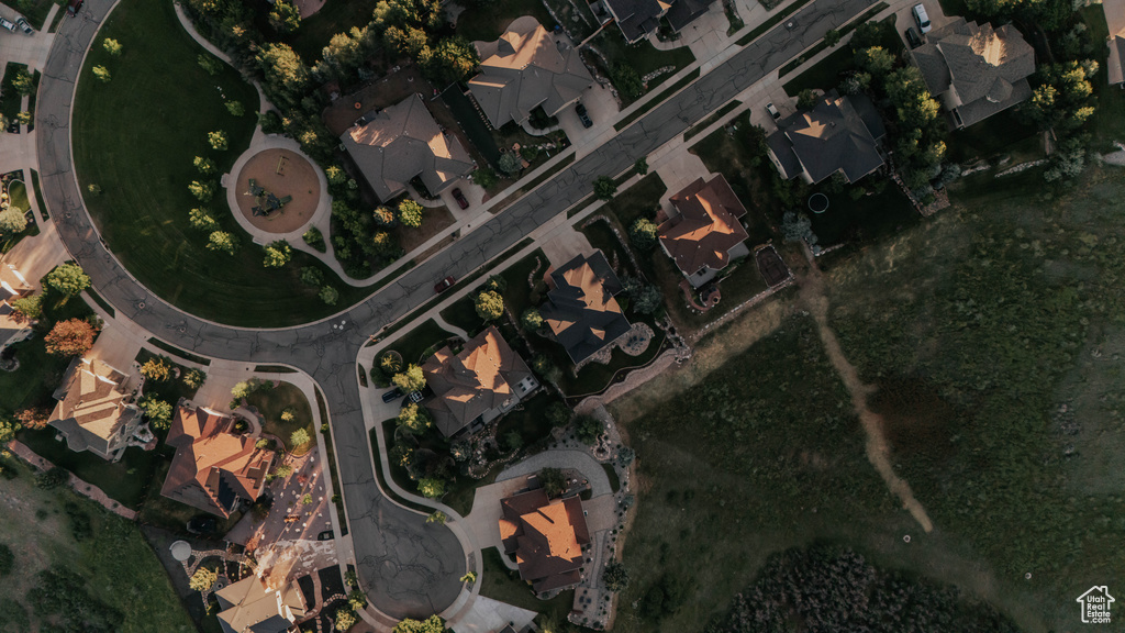 Aerial view of property and surrounding area featuring nearby suburban area