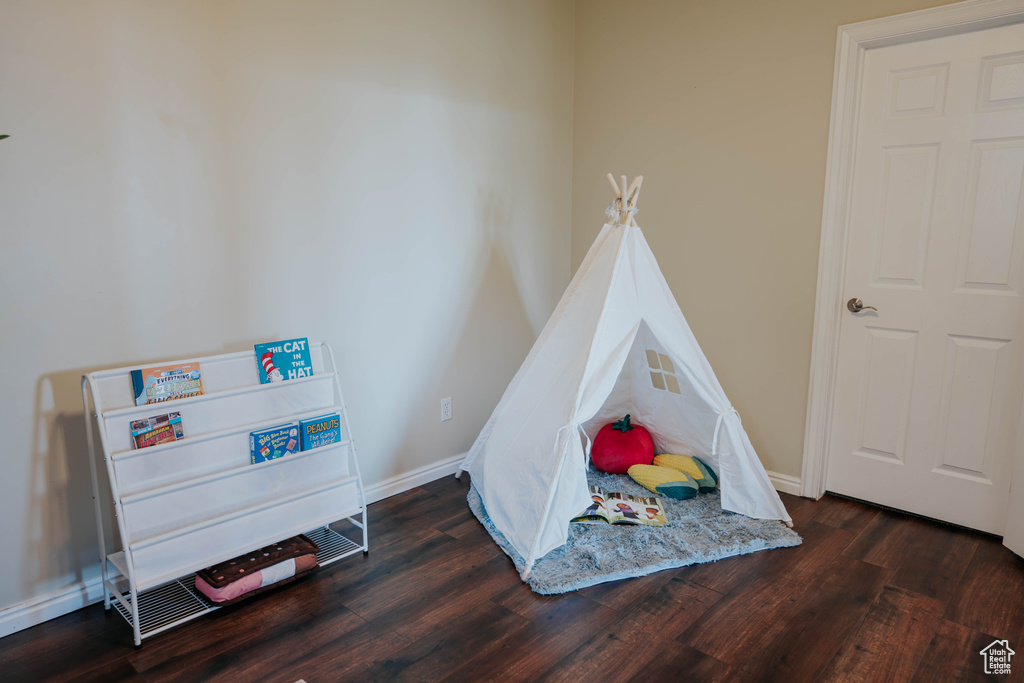 Recreation room featuring wood finished floors and baseboards