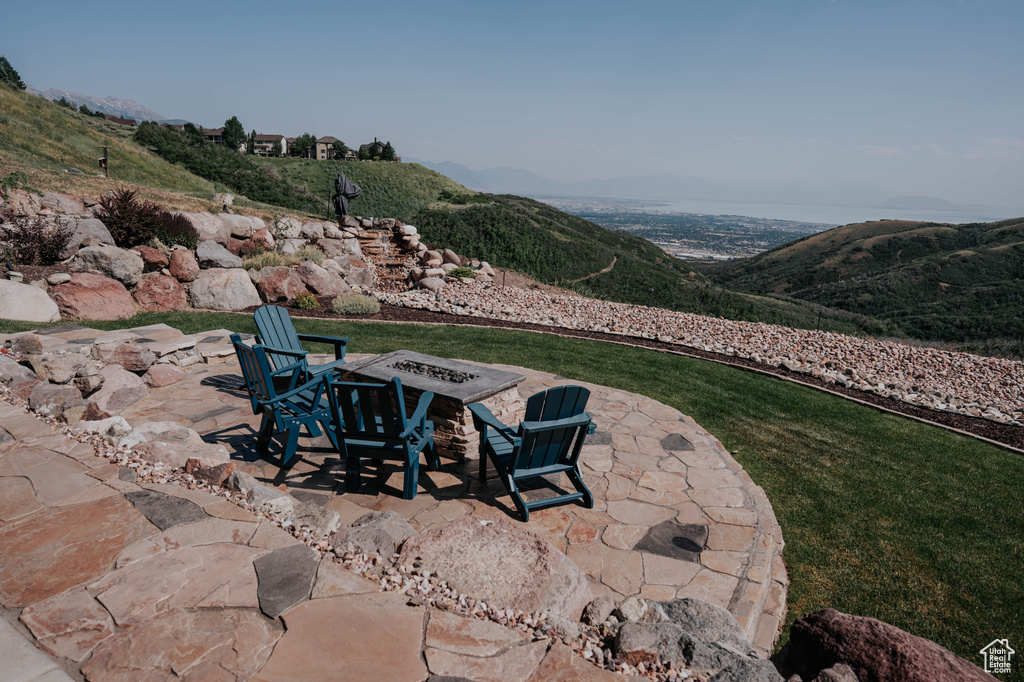View of patio / terrace with a mountain view and a fire pit
